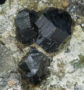 Cassiterite with Arsenopyrite, Fluorapatite, Calcite and Muscovite. 