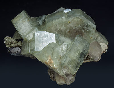 Fluorapatite with Ferberite, Siderite, Quartz and Muscovite.