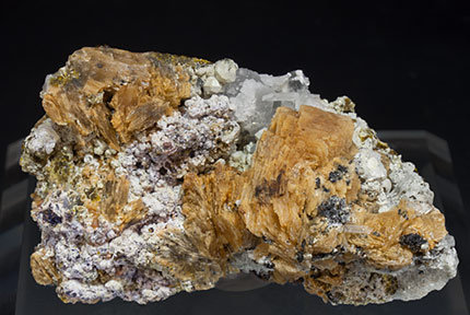 Roweite with Olshanskyite, Andradite and Calcite. 