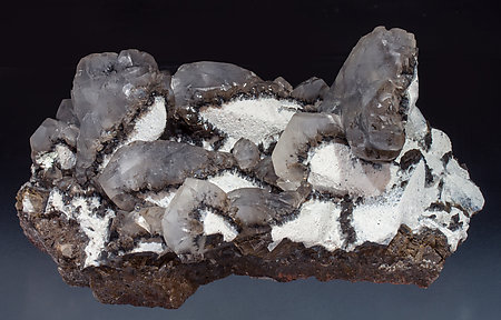 Twinned Calcite with Calcite, Palygorskite and manganese oxides. Front