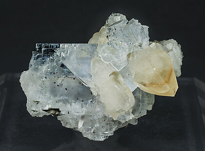 Fluorite with inclusions of Cinnabar and sulphides, with Calcite. Side