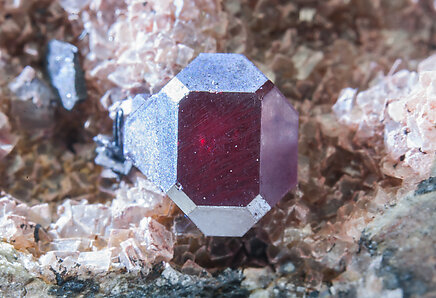 Cuprite with Calcite. Detail with light behind