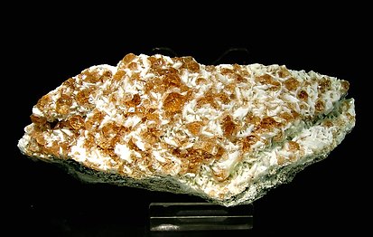 Grossular (variety hessonite) with Pectolite. 