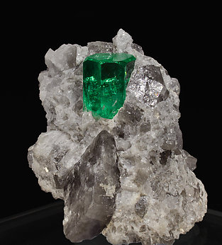 Beryl (variety emerald) on Calcite. side