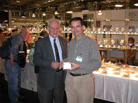 Jordi Fabre in front of his stand at the Munich 2002 show, along with Professor Curzio Cipriani 