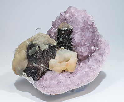 Quartz (variety amethyst) with Calcite and Hematite.