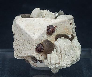 Garnet (Group) with Quartz (varity smoky), Microcline and Albite. 