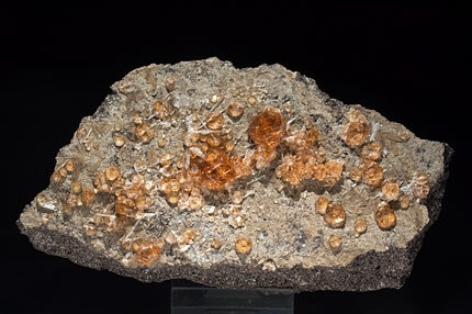 Grossular (variety hessonite) with Wollastonite and Fluorapophyllite-(K) .