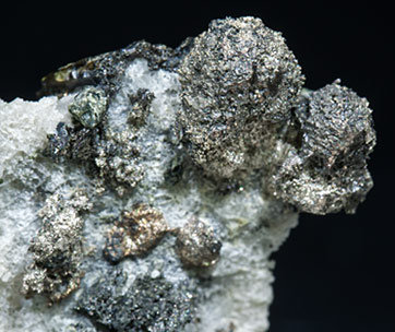 Silver with Arsenopyrite silver-rich Tennantite and Pearceite. 