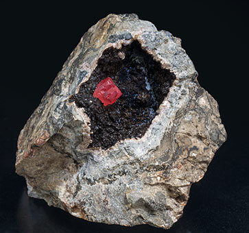 Rhodochrosite with manganese oxides.