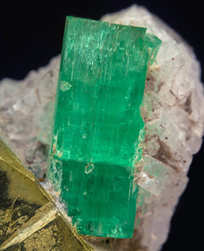 Beryl (variety emerald) with Pyrite and Calcite. 