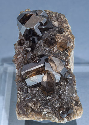 Cassiterite with Muscovite and Quartz (variety smoky).