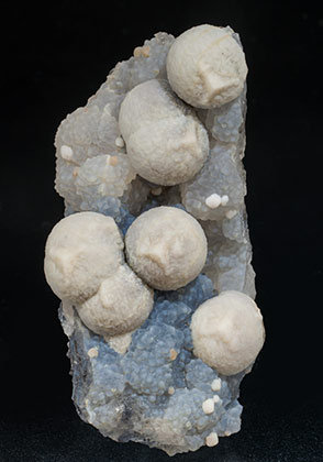 Calcite on Quartz (variety chalcedony). 