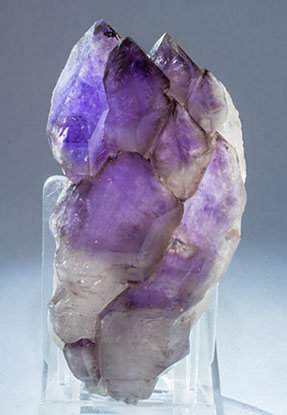 Quartz (variety amethyst) with Quartz (variety smoky). Light behind