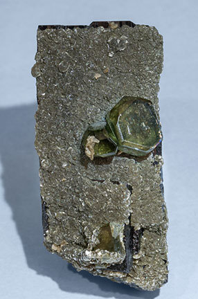 Fluorapatite with Ferberite, Siderite and Muscovite.