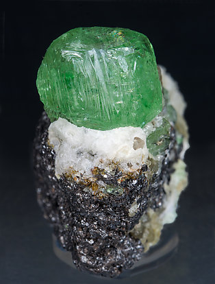 Grossular (variety tsavorite) with Pyrite and Graphite.