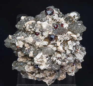 Almandine-Spessartine (Series) with Orthoclase and Quartz (variety smoky). 