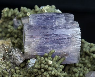 Fluorapatite with Muscovite, Chlorite, Pyrite and Quartz. 