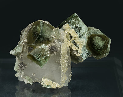 Fluorapatite with Quartz, Siderite and Muscovite.