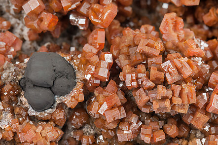 Vanadinite with manganese oxides and Quartz. 