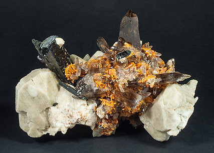 Zircon with Quartz (variety smoky), Orthoclase and Aegirine.