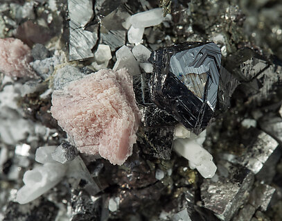 Arsenopyrite with Rhodochrosite, Quartz and Pyrite after Pyrrhotite. 