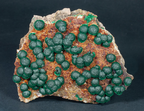 Malachite on Quartz with Goethite inclusions. 