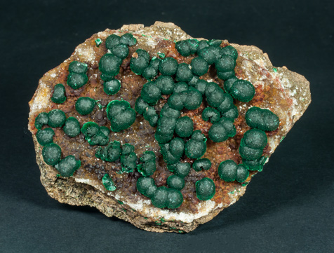 Malachite on Quartz with Goethite inclusions. 