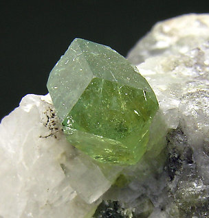 Andradite (variety demantoid chromium rich). 