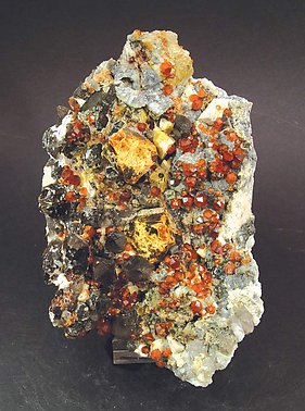 Helvine with Spessartine, smoky Quartz and Feldspar.