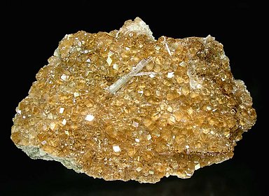 Grossular (variety hessonite) with Wollastonite.