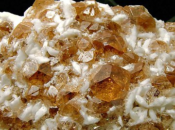 Grossular (variety hessonite) with Pectolite. 