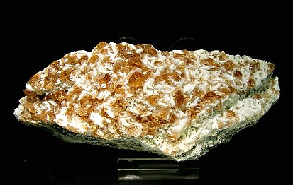 Grossular (variety hessonite) with Pectolite.