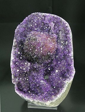 Calcite with Quartz (variety amethyst) and Hematite.