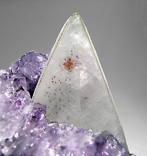 Calcite with Quartz (variety amethyst) and Hematite. 