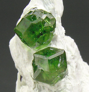 Andradite (variety demantoid) with Amphibole. 