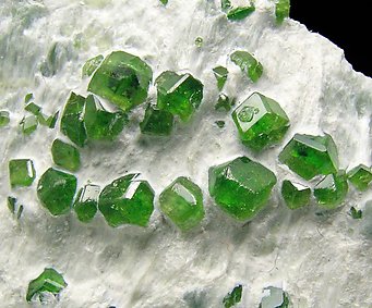 Andradite (variety demantoid) with Amphibole. 