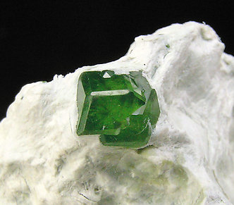 Andradite (variety demantoid) with Amphibole. 