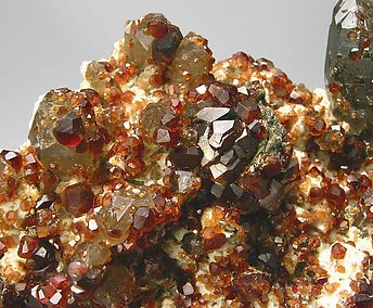 Spessartine with smoky Quartz and Feldspar. 