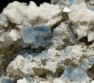 Fluorapatite with Bertrandite, Albite, Muscovite and Quartz. 