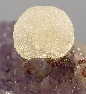 Quartz (variety amethyst) with Calcite and Hematite. 