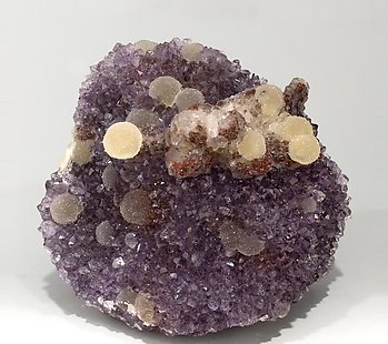 Quartz (variety amethyst) with Calcite and Hematite.