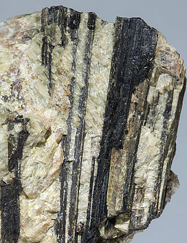 Allanite-(Ce) with Muscovite, Spessartine and perthite. 