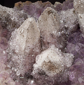 Calcite on Quartz (variety amethyst) and Hematite. 